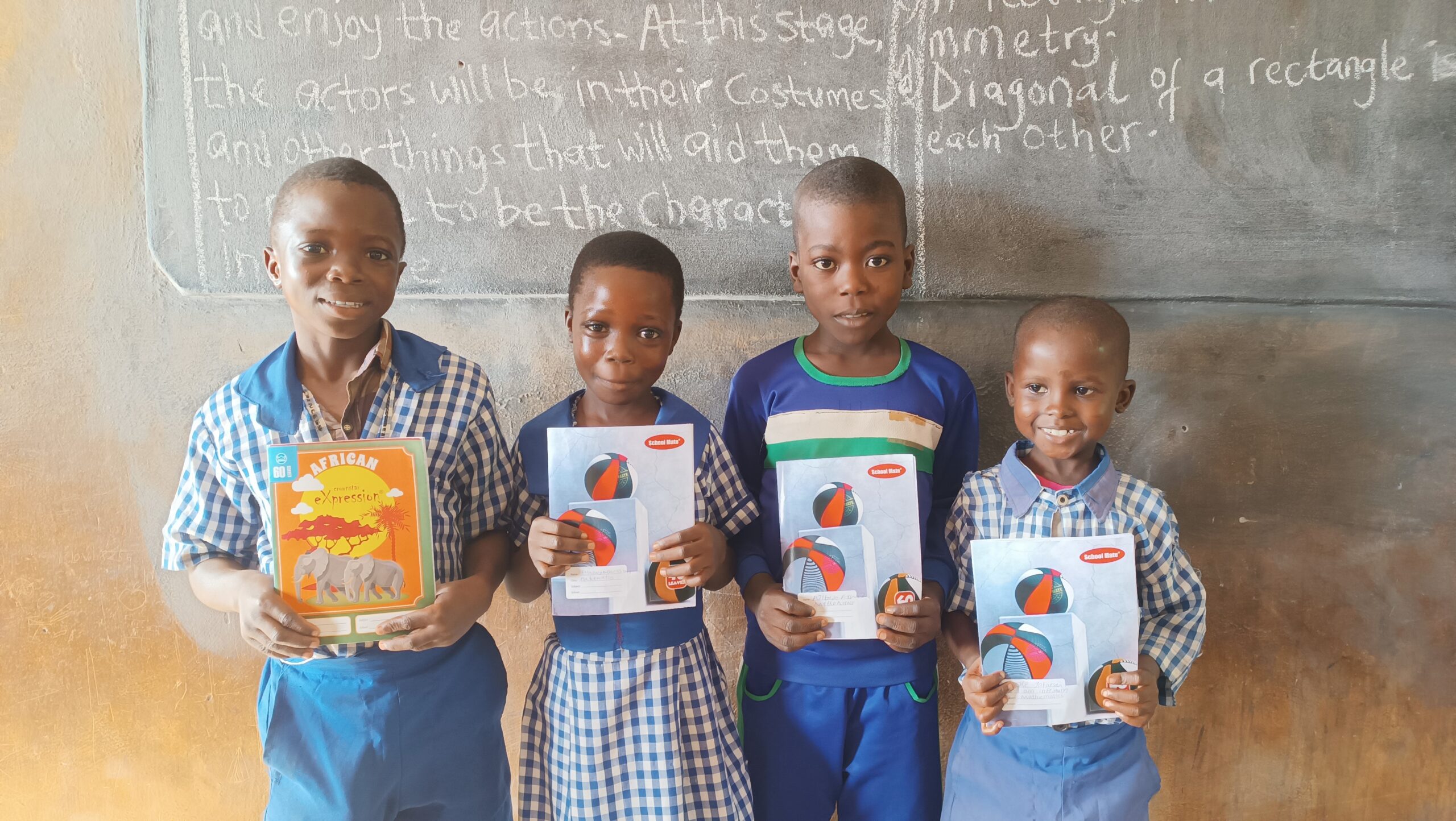 An artist in front a mural with arms open