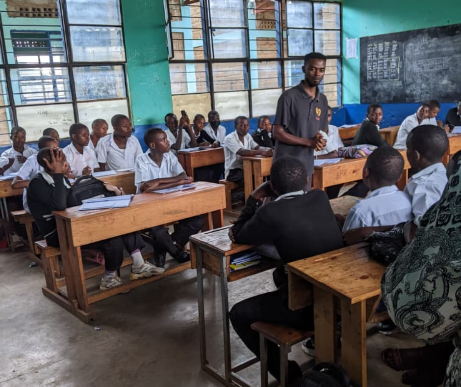 Aime Ishimwe teaching to a class of students